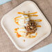 An EcoChoice square palm leaf plate with dessert and ice cream on a table.