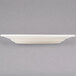 A Tuxton Reno eggshell white china plate with a wide rim.
