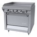 A commercial stainless steel griddle with manual controls and an oven, designed for liquid propane use.