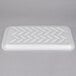 A white styrofoam tray with zigzag lines.