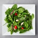 An American Metalcraft square melamine platter with a spinach salad with tomatoes and onions.
