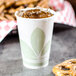 A Bare by Solo wax treated paper cold cup with a pretzel on a table.