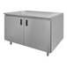 A stainless steel Advance Tabco work table with hinged doors and a midshelf.