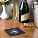 A Stolzle flute glass of champagne on a table.