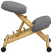 A Flash Furniture wooden office chair with a grey cushion and wheels.
