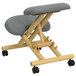 A Flash Furniture wooden office chair with wheels and a grey cushion.