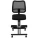 A black Flash Furniture office kneeling chair with wheels and a mesh back.