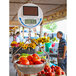 A Cardinal Detecto hanging scale with tomatoes in it.