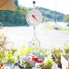 A Cardinal Detecto hanging scale with peaches in a bowl.