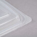 A close-up of a Genpak clear rectangular plastic container with a lid.