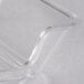 A clear plastic cover with a curved edge on a white surface.