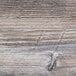 A close-up of a wood surface with scratches.