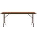 A medium oak Correll rectangular folding table with a metal frame.