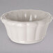 a white bowl with a scalloped edge