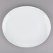 A Tuxton bright white oval china platter with a white rim.