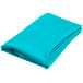A folded teal blue round cloth table cover.