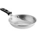 A Vollrath Wear-Ever aluminum frying pan with a black silicone handle.