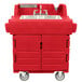 A red plastic Cambro self-contained hand sink on wheels.