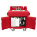 A red plastic Cambro hand sink cart with a sink and faucet.