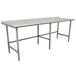 An Advance Tabco stainless steel work table with a backsplash on a white surface.