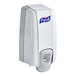 A white Purell NXT hand sanitizer dispenser with a logo on it.