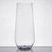 A clear plastic stemless flute on a white surface.