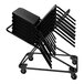 A National Public Seating Melody Stack Chair Dolly stacked with black chairs.