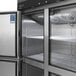 A Turbo Air M3 Series stainless steel reach-in freezer with half doors open and shelves inside.