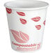 A white EcoChoice paper hot cup with red leaf print.