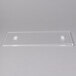 A clear plastic tray with a clear rectangular object with a black border and two white holes.