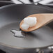 A wooden spoon with coconut oil on it.