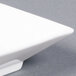 A close-up of a bright white square porcelain bowl.