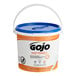 A white bucket of GOJO Fast Towels hand cleaning wipes.