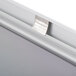 A close up of a satin aluminum snap frame on a white wall.