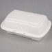 A white Genpak styrofoam hinged lid container.