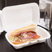 A sandwich in a white Genpak foam hinged lid container.