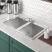 A Regency stainless steel drop-in sink with two bowls.
