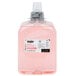 A plastic bottle of pink liquid hand soap.