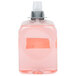A plastic container of pink liquid hand soap.