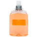 A plastic container of orange liquid hand soap.