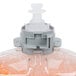 A plastic bottle of orange liquid hand soap with a plastic cap.