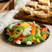 A plate of fajita vegetables cooked in a Lodge cast iron skillet.