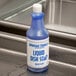 A blue bottle of Advantage Chemicals concentrated liquid dish soap on a counter.