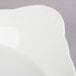 A white stoneware dish with a curved edge.