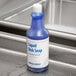 A blue bottle of Advantage Chemicals liquid dish soap with a white label on a countertop.