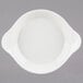 A white stoneware shirred egg dish with handles.
