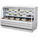 A white Turbo Air refrigerated bakery display case filled with cakes and pastries.