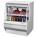 A white Turbo Air refrigerated deli case with food inside.