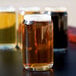 A group of Libbey Glass Can Tasting Glasses filled with beer on a table.