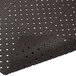 A black rubber Cactus Mat with holes in it.